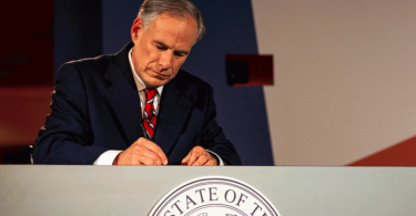 Texas Governor Greg Abbott writes notes before a gubernatorial debate against his Democratic challenger Lupe Valdez at the LBJ Library in Austin, Texas, on Friday, Sept. 28, 2018. (Nick Wagner/Austin American-Statesman via AP, Pool)